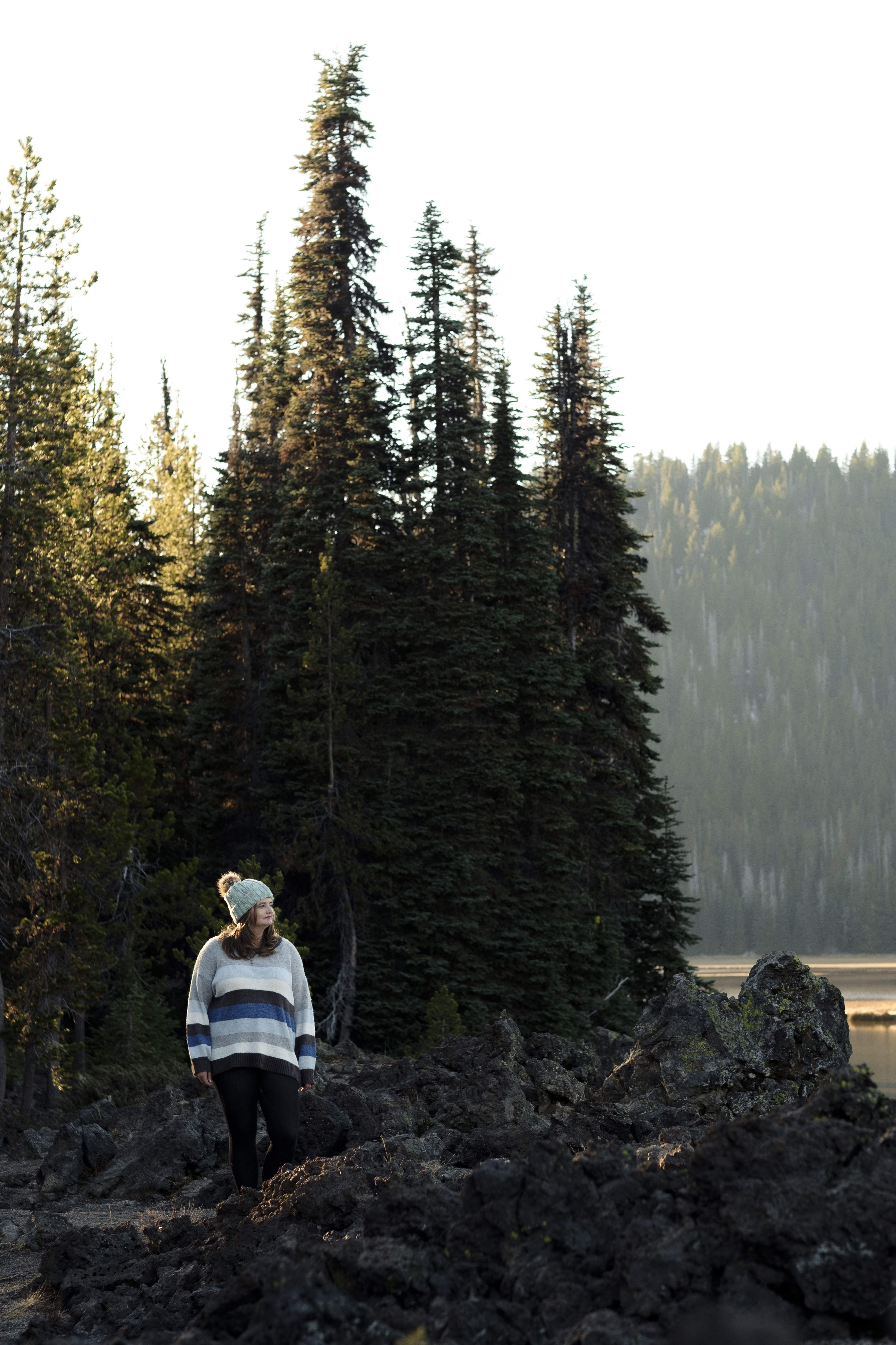 Woman walking through a forest in a flowing red dress